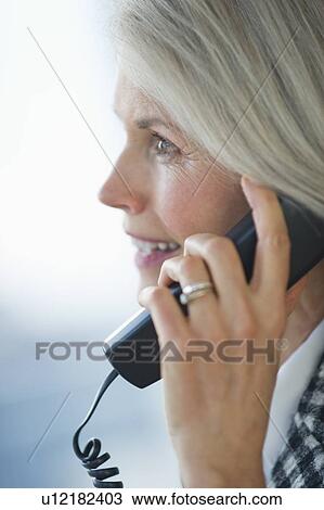 Portrait of senior businesswoman talking on phone View Large Photo Image Stock Image - Portrait of senior businesswoman talking on phone. Fotosearch