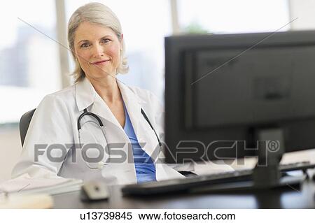 Stock Photography - Portrait of senior female doctor in her office. Fotosearch