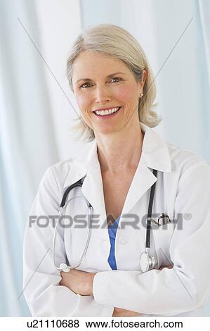 Portrait of senior female doctor smiling View Large Photo Image Stock Photo - Portrait of senior female doctor smiling. Fotosearch