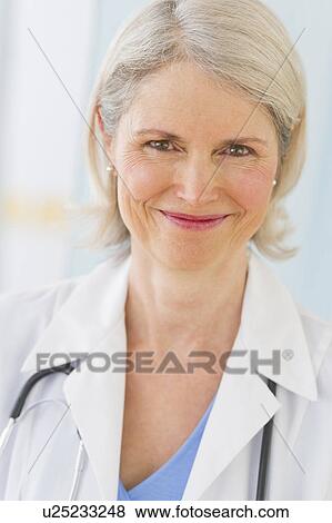 Portrait of senior female doctor smiling View Large Photo Image Stock Photo - Portrait of senior female doctor smiling. Fotosearch