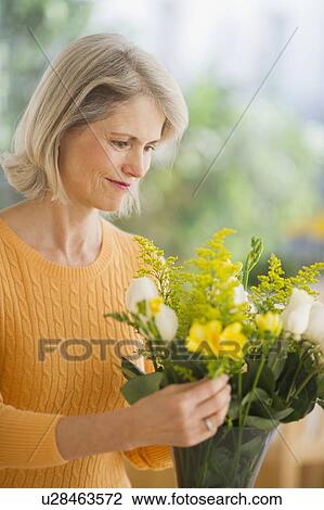 Portrait of senior woman arranging bouquet in Mother's Day View Large Photo Image Stock Image - Portrait of senior woman arranging bouquet in Mother's Day. Fotosearch