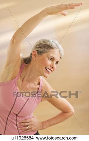 Picture - Portrait of senior woman exercising in gym. Fotosearch