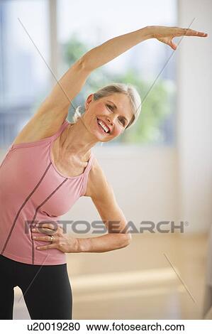 Portrait of senior woman exercising in gym View Large Photo Image Stock Image - Portrait of senior woman exercising in gym. Fotosearch