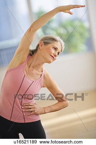 Portrait of senior woman exercising in gym View Large Photo Image Stock Photo - Portrait of senior woman exercising in gym. Fotosearch