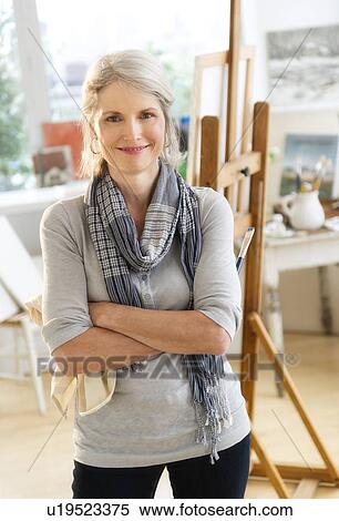 Stock Photography - Portrait of senior woman in art studio. Fotosearch