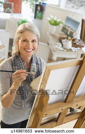 Portrait of senior woman painting on canvas View Large Photo Image Stock Image - Portrait of senior woman painting on canvas. Fotosearch