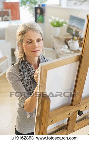 Portrait of senior woman painting on canvas View Large Photo Image Stock Image - Portrait of senior woman painting on canvas. Fotosearch