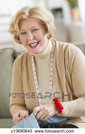 Portrait of senior woman sewing View Large Photo Image Stock Image - Portrait of senior woman sewing. Fotosearch