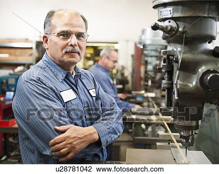 Stock Image - Portrait of skilled worker in factory. Fotosearch