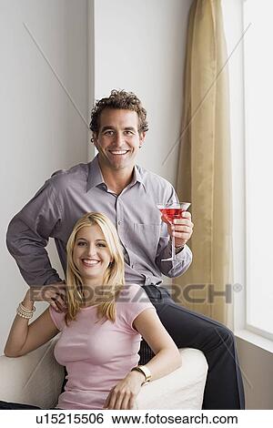 Portrait of smiling couple at home party View Large Photo Image Stock Photograph - Portrait of smiling couple at home party. Fotosearch