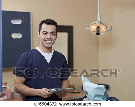 Portrait of smiling dentist in surgery View Large Photo Image Stock Image - Portrait of smiling dentist in surgery. Fotosearch