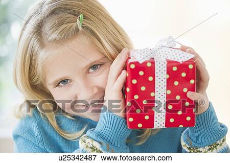 Portrait of smiling girl (8-9) holding gift View Large Photo Image Stock Photo - Portrait of smiling girl (8-9) holding gift. Fotosearch