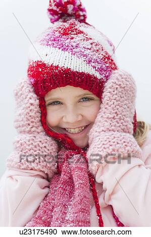 Portrait of smiling girl (8-9) wearing winter clothing View Large Photo Image Stock Image - Portrait of smiling girl (8-9) wearing winter clothing. Fotosearch