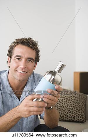 Portrait of smiling man holding cocktail shaker View Large Photo Image Picture - Portrait of smiling man holding cocktail shaker. Fotosearch