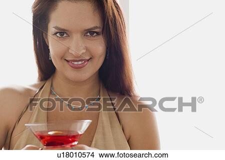 Portrait of smiling mid adult woman holding cocktail View Large Photo Image Picture - Portrait of smiling mid adult woman holding cocktail. Fotosearch