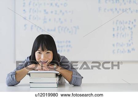 Portrait of smiling woman in front of board with equations View Large Photo Image Stock Image - Portrait of smiling woman in front of board with equations. Fotosearch