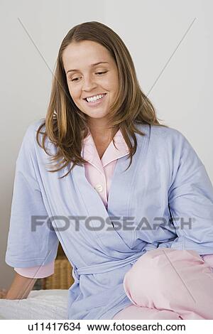 Picture - Portrait of smiling woman in pajamas. Fotosearch