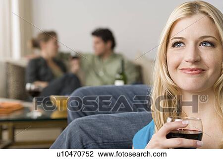 Portrait of smiling woman with couple in background View Large Photo Image Stock Image - Portrait of smiling woman with couple in background. Fotosearch
