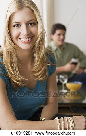Portrait of smiling woman with man in background View Large Photo Image Stock Image - Portrait of smiling woman with man in background. Fotosearch