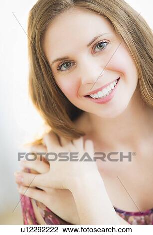 Stock Image - Portrait of smiling young woman. Fotosearch