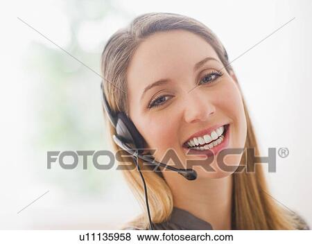 Stock Photo - Portrait of smiling young woman with headphones. Fotosearch