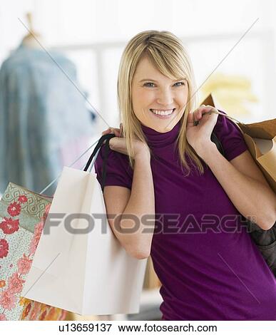 Portrait of woman holding shopping bags View Large Photo Image Stock Photo - Portrait of woman holding shopping bags. Fotosearch