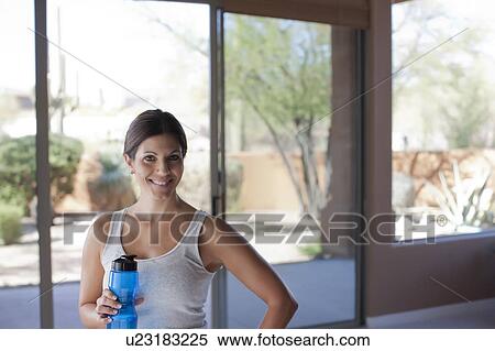Portrait of woman holding water bottle View Large Photo Image Stock Photography - Portrait of woman holding water bottle. Fotosearch
