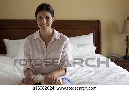 Portrait of woman reading on bed View Large Photo Image Picture - Portrait of woman reading on bed. Fotosearch