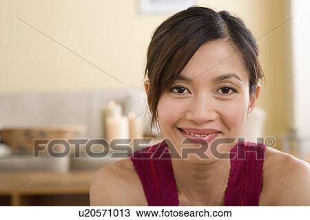 Stock Image - Portrait of woman smiling. Fotosearch