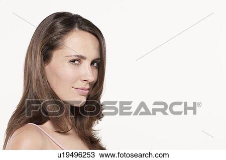 Stock Image - Portrait of woman, studio shot. Fotosearch