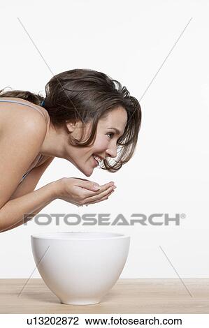 Portrait of woman washing face, studio shot View Large Photo Image Stock Image - Portrait of woman washing face, studio shot. Fotosearch