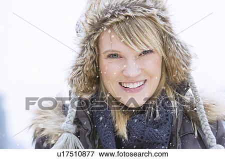 Stock Photo - Portrait of woman wearing knit hat smiling. Fotosearch