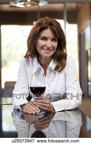 Stock Photo - Portrait of woman with glass of wine. Fotosearch