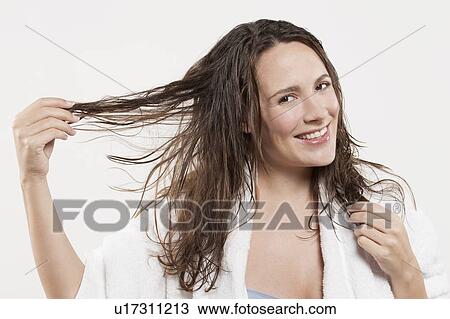 Portrait of woman with long wet hair, studio shot View Large Photo Image Stock Image - Portrait of woman with long wet hair, studio shot. Fotosearch