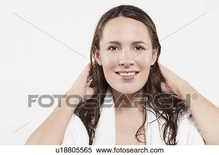 Portrait of woman with long wet hair, studio shot View Large Photo Image Stock Photography - Portrait of woman with long wet hair, studio shot. Fotosearch