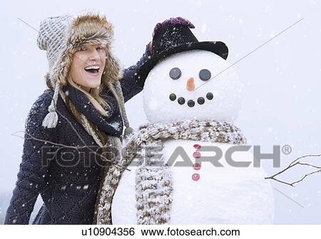 Portrait of woman with snowman View Large Photo Image Stock Photograph - Portrait of woman with snowman. Fotosearch
