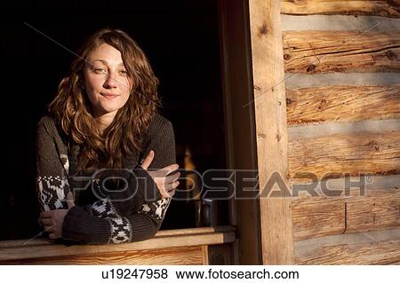 Stock Photo - Portrait of young woman looking at camera. Fotosearch