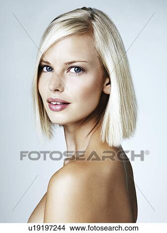 Portrait of young woman on light blue background View Large Photo Image Picture - Portrait of young woman on light blue background. Fotosearch