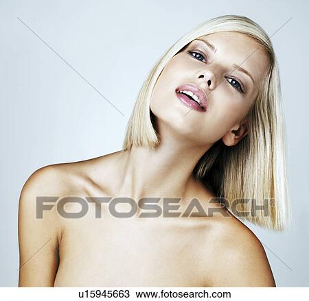 Stock Image - Portrait of young woman on light blue background. Fotosearch