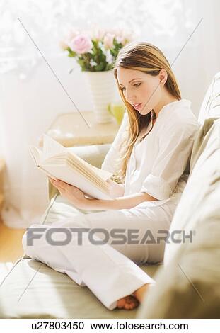 Portrait of young woman reading book View Large Photo Image Stock Image - Portrait of young woman reading book. Fotosearch