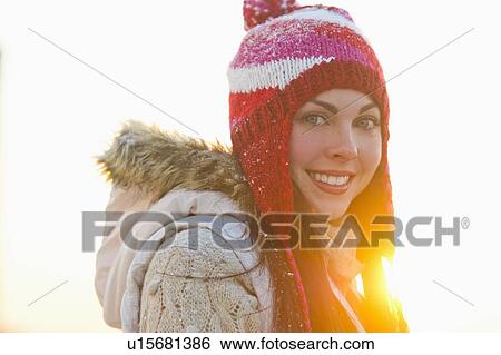 Stock Photograph - Portrait of young woman wearing knit hat. Fotosearch