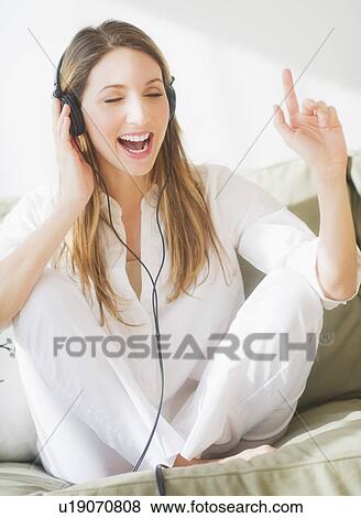 Portrait of young woman wearing headphones View Large Photo Image Stock Photo - Portrait of young woman wearing headphones. Fotosearch
