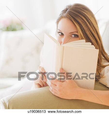 Stock Image - Portrait of young woman with book. Fotosearch