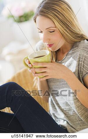 Portrait of young woman with mug View Large Photo Image Stock Photo - Portrait of young woman with mug. Fotosearch