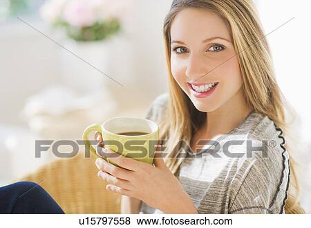 Portrait of young woman with mug View Large Photo Image Stock Photo - Portrait of young woman with mug. Fotosearch