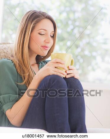 Stock Photo - Portrait of young woman with mug. Fotosearch
