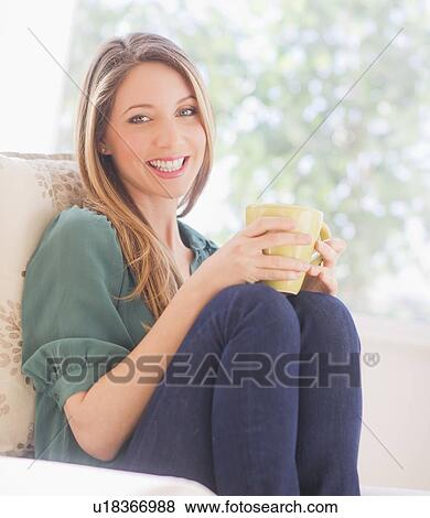 Portrait of young woman with mug View Large Photo Image Stock Photo - Portrait of young woman with mug. Fotosearch
