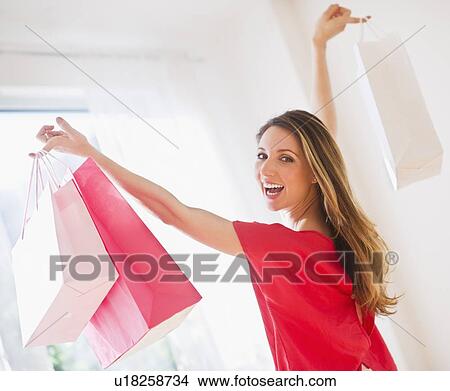 Portrait of young woman with shopping bags View Large Photo Image Picture - Portrait of young woman with shopping bags. Fotosearch