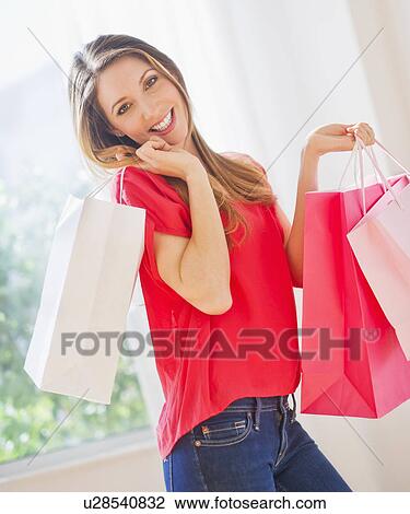 Portrait of young woman with shopping bags View Large Photo Image Stock Image - Portrait of young woman with shopping bags. Fotosearch