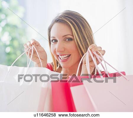 Portrait of young woman with shopping bags View Large Photo Image Stock Photo - Portrait of young woman with shopping bags. Fotosearch
